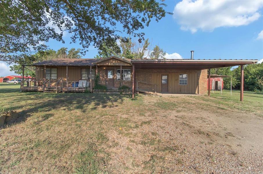View of front of home with a carport and a front yard View of front of home with a carport and a front yard