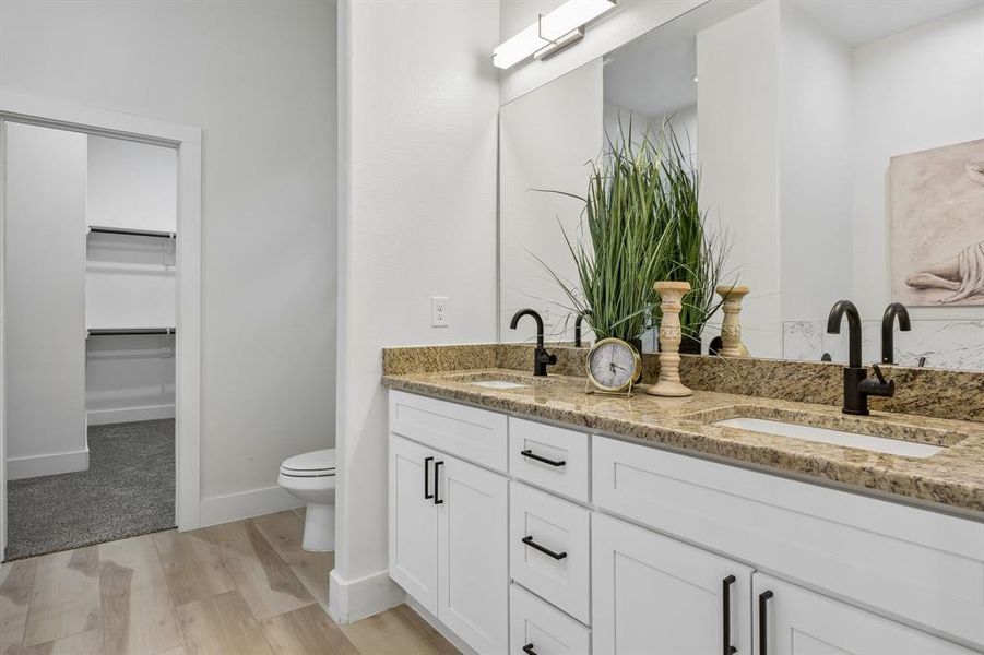 Dual vanity with light-toned countertop and integrated sinks