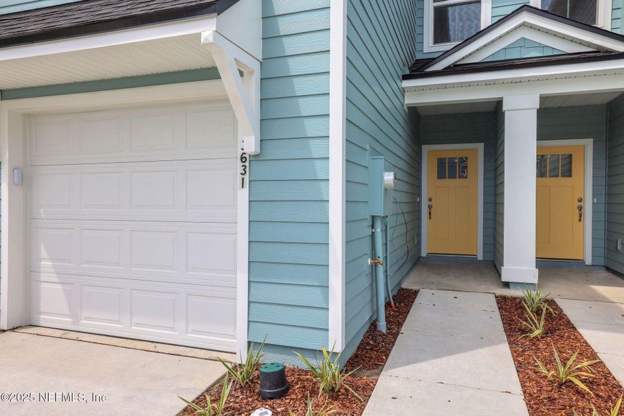 Front exterior of a new home in Atlantis Pointe, Middleburg, FL, highlighting curb appeal (Image 1).