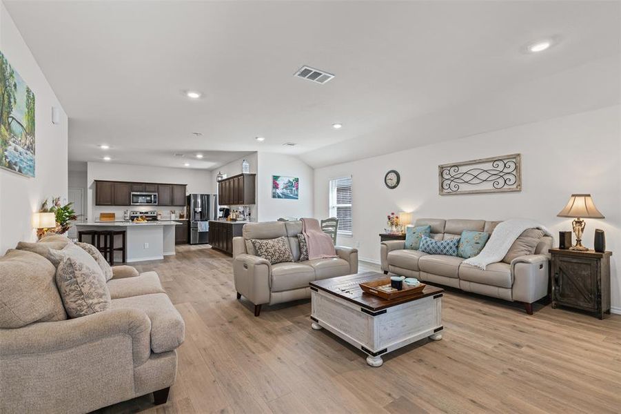 Spacious open-layout living area with modern recessed lighting and seamless flow into the kitchen and dining spaces. Spacious open-layout living area with modern recessed lighting and seamless flow into the kitchen and dining spaces.