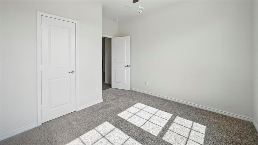Unfurnished bedroom with carpet and baseboards