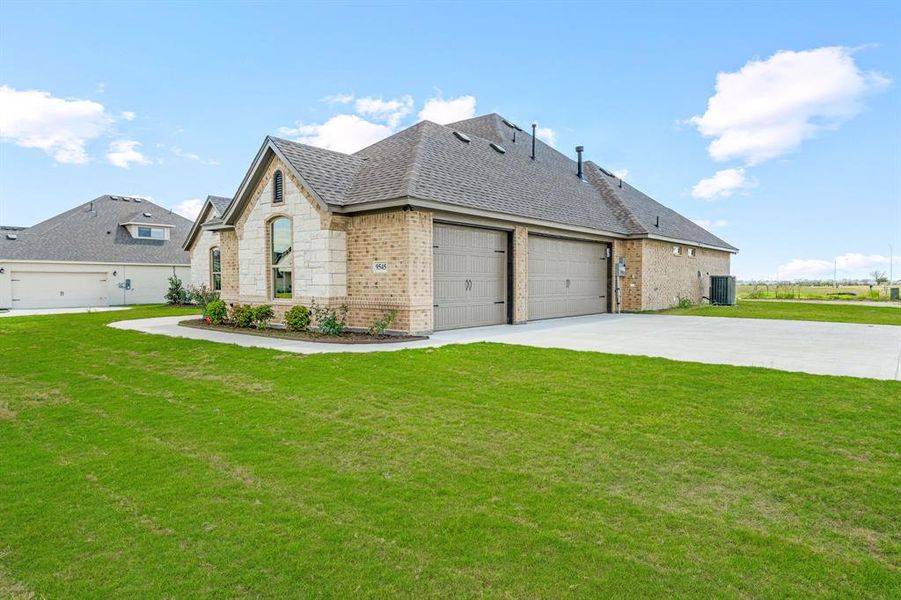 View of front facade featuring a front yard and brick siding