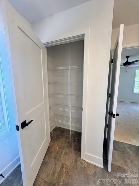 linen closet in primary bathroom