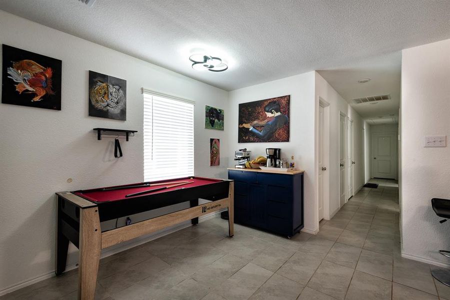 Playroom featuring billiards and a textured ceiling