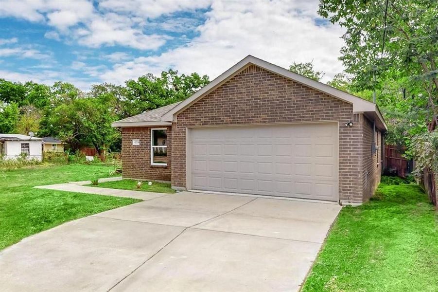 Ranch-style home featuring a front lawn