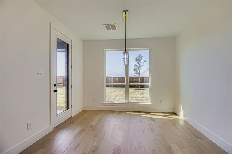 Unfurnished dining area with plenty of natural light and light wood finished floors Unfurnished dining area with plenty of natural light and light wood finished floors