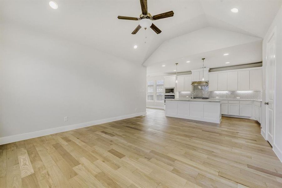 Unfurnished living room with ceiling fan, recessed lighting, and light wood finished floors