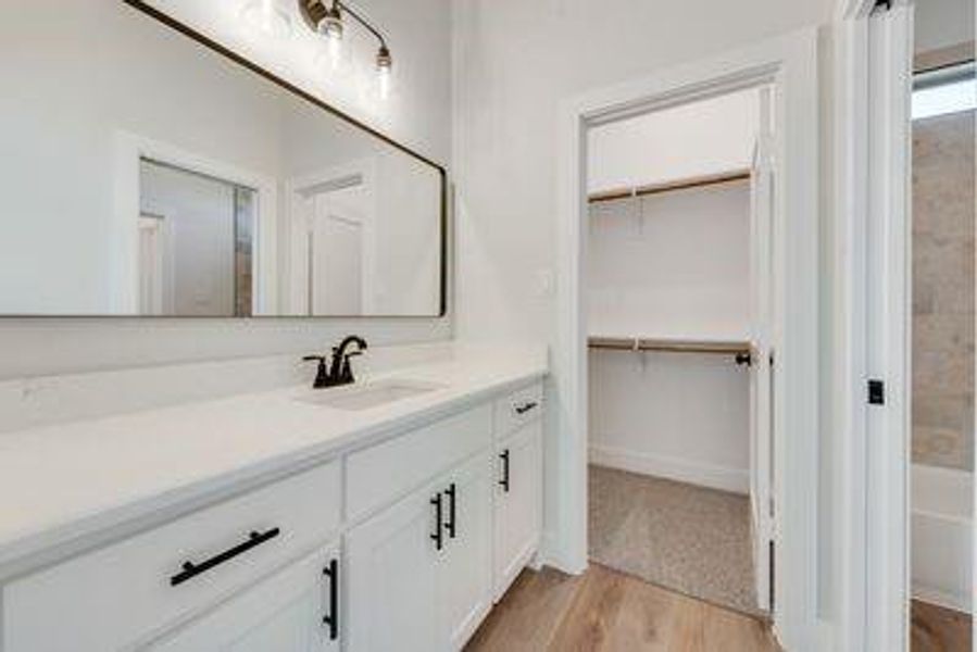 Bathroom featuring vanity and wood-type flooring