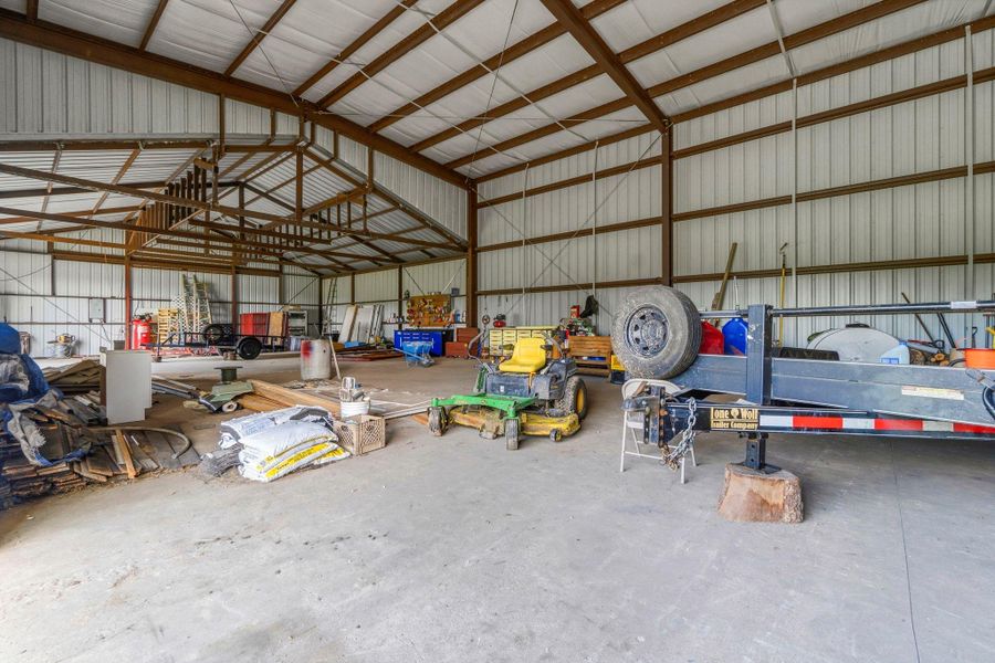 This section of the shop features a 20-ft insulated ceiling, providing generous height ideal for vehicle lifts, large equipment, and versatile workspace needs.