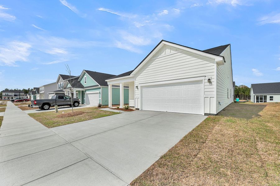 Front exterior of a new home in , Ravenel, SC, highlighting curb appeal (Image 20).