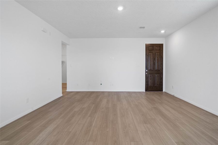 Bring family and friends together in this beautiful family room! It features high ceilings, recessed lighting, ceiling fan with lighting, custom paint, stunning Bandera vinyl plank flooring in French Oak, and large windows that fill the space with natural light all day long.