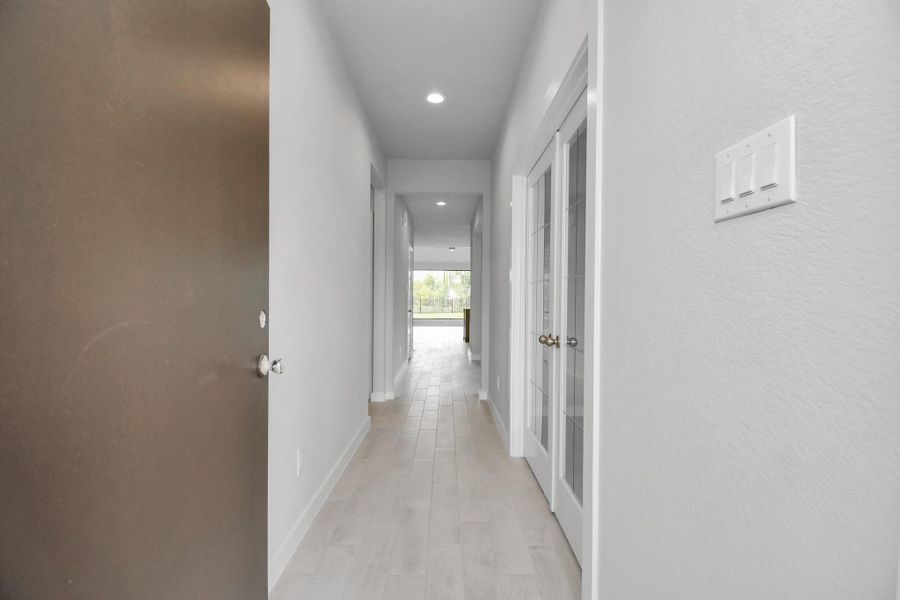 As you step into the threshold of this luxurious home, you'll soon be welcomed by an elegant glass door (to be installed). Inside, soaring ceilings amplify the spaciousness, while the refined wood-look tile flooring and oversized baseboards exude sophistication and charm. Sample photo of completed home with similar floor plan. Actual colors and selections may vary.