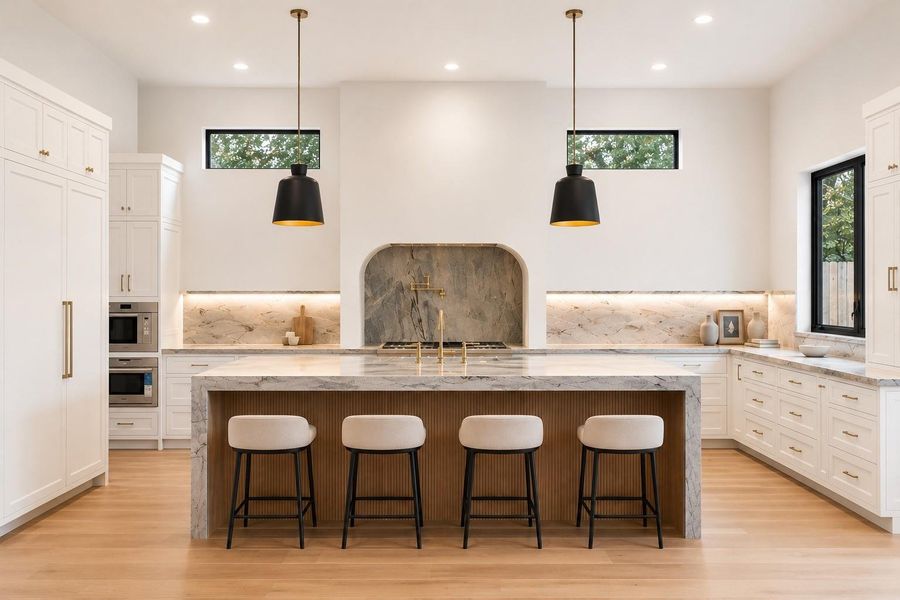 Designed to impress, the kitchen pairs a dramatic waterfall island with fully inset, floor to ceiling cabinetry and a statement vent surround. High end natural stone throughout the home - quartzite, cristallo quartzite, limestone, onyx, marble, and soapstone - sets the tone here, where an upgraded Thermador package with a panel ready fridge/freezer combo elevates everyday function, alongside a seamless connection to the scullery. **Virtually staged**