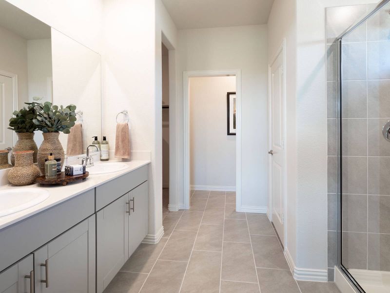 Primary bathroom with double vanity and large walk-in closet