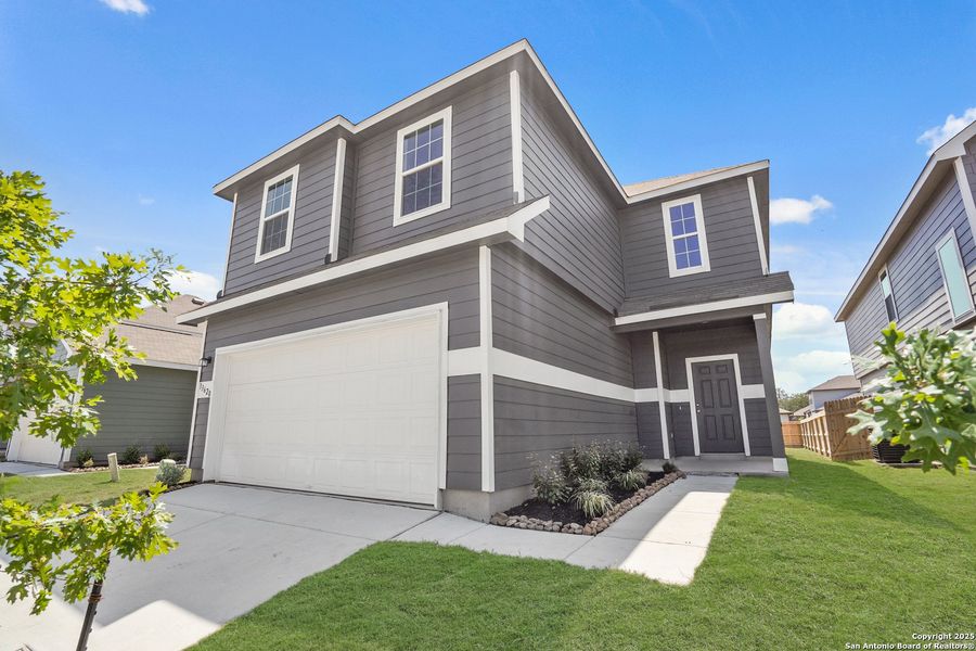Front exterior of a new home in Abbott Place, St. Hedwig, TX, highlighting curb appeal (Image 16).