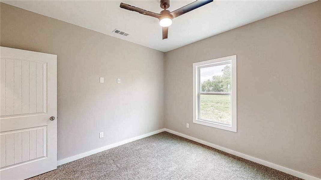 Back bedroom with remote ceiling fan