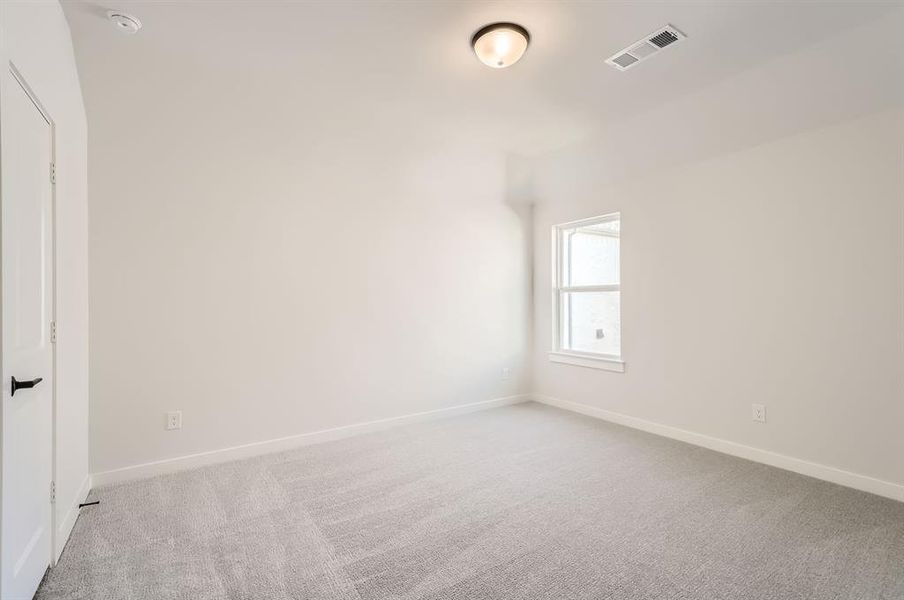 Unfurnished room featuring light colored carpet