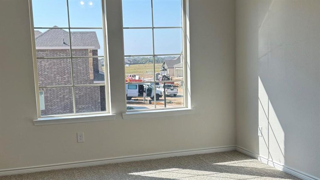 Spare room with plenty of natural light and carpet Spare room with plenty of natural light and carpet