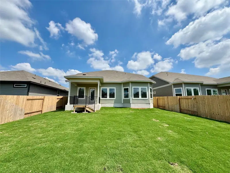 Rear view of property featuring a fenced backyard Rear view of property featuring a fenced backyard