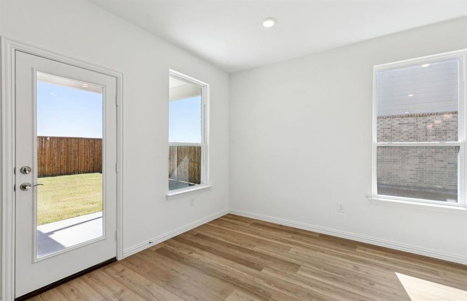Dining nook off kitchen with large windows