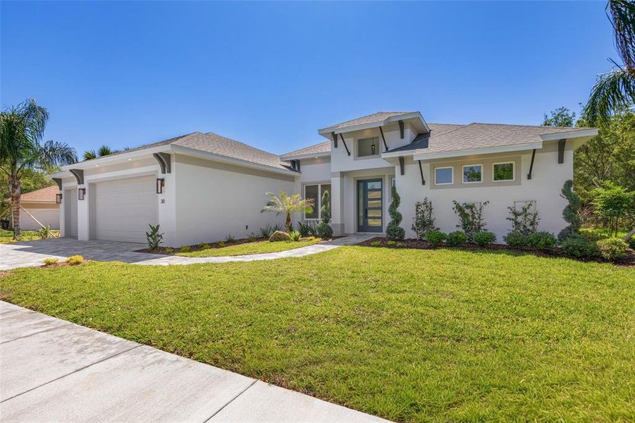 Front exterior of a new home in , Palm Coast, FL, highlighting curb appeal (Image 1). Front exterior of a new home in , Palm Coast, FL, highlighting curb appeal (Image 1).