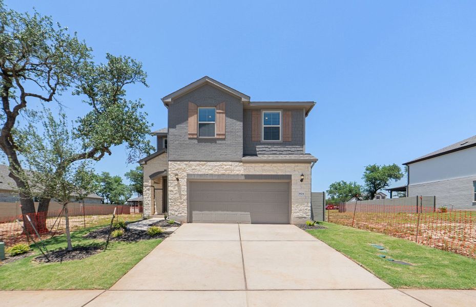 Front exterior of a new home in Wolf Ranch, Georgetown, TX, highlighting curb appeal (Image 23). Front exterior of a new home in Wolf Ranch, Georgetown, TX, highlighting curb appeal (Image 23).