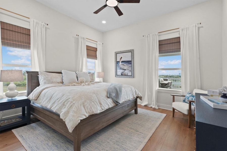 The primary King sized bedroom is conveniently located on the first floor. It has a bright and airy decor and features large windows with beautiful views, a king bed, and tasteful decor and Framed Samsun TV. Perfect for relaxation and comfort. Ensuite bathroom with walk in closet.