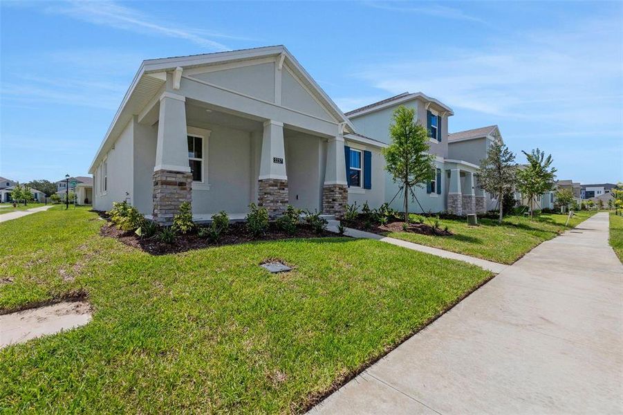 Front exterior of a new home in Crossroads at Kelly Park, Apopka, FL, highlighting curb appeal (Image 30).