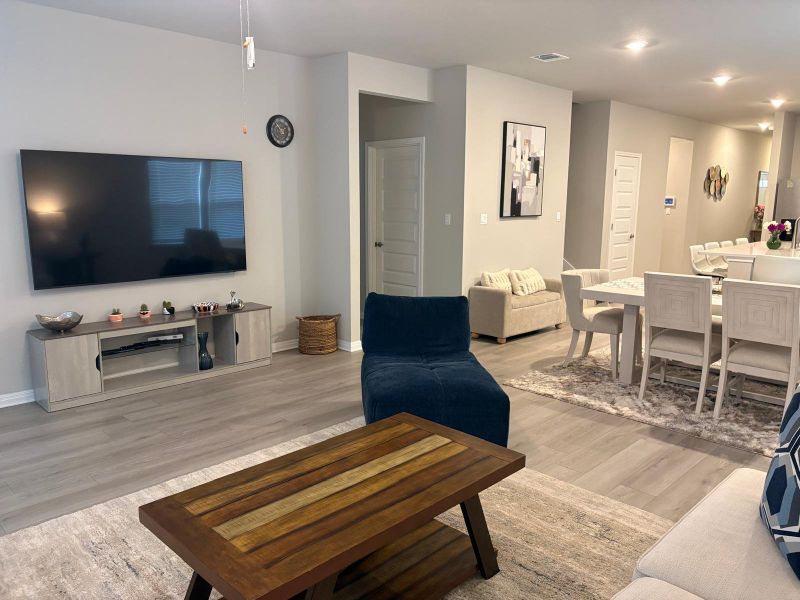 An open floorplan seamlessly connects a comfortable living area with a refined dining space.