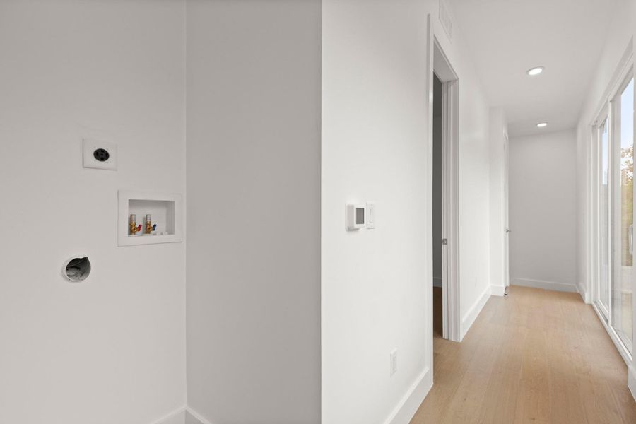 Dedicated laundry area in the upstairs hallway