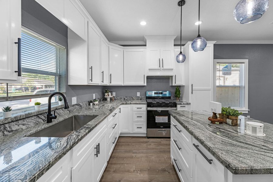 Stainless gas stove, custom vent hood, built in trash bin, spice rack, lazy Susan's, soft closing cabinets, you must see this one in person to see what it all offers!