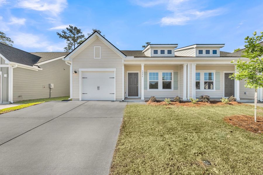 Front exterior of a new home in Tea Farm, Ravenel, SC, highlighting curb appeal (Image 1). Front exterior of a new home in Tea Farm, Ravenel, SC, highlighting curb appeal (Image 1).