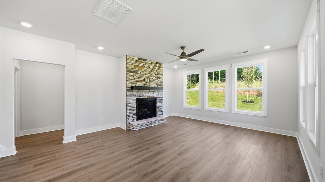Spacious family room with rich hardwood flooring and elegant trim work in a reputable DRB Homes build