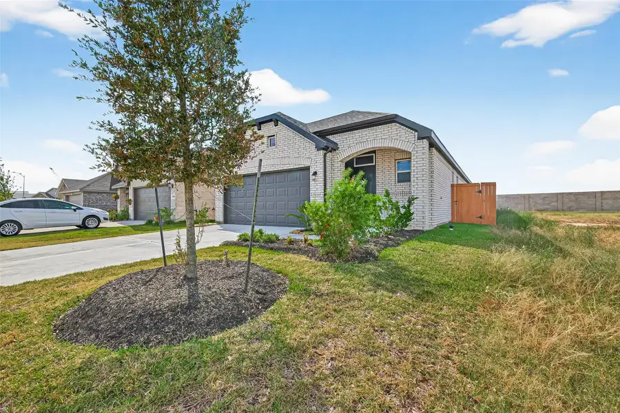 Front exterior of a new home in Sunterra, Katy, TX, highlighting curb appeal (Image 26). Front exterior of a new home in Sunterra, Katy, TX, highlighting curb appeal (Image 26).