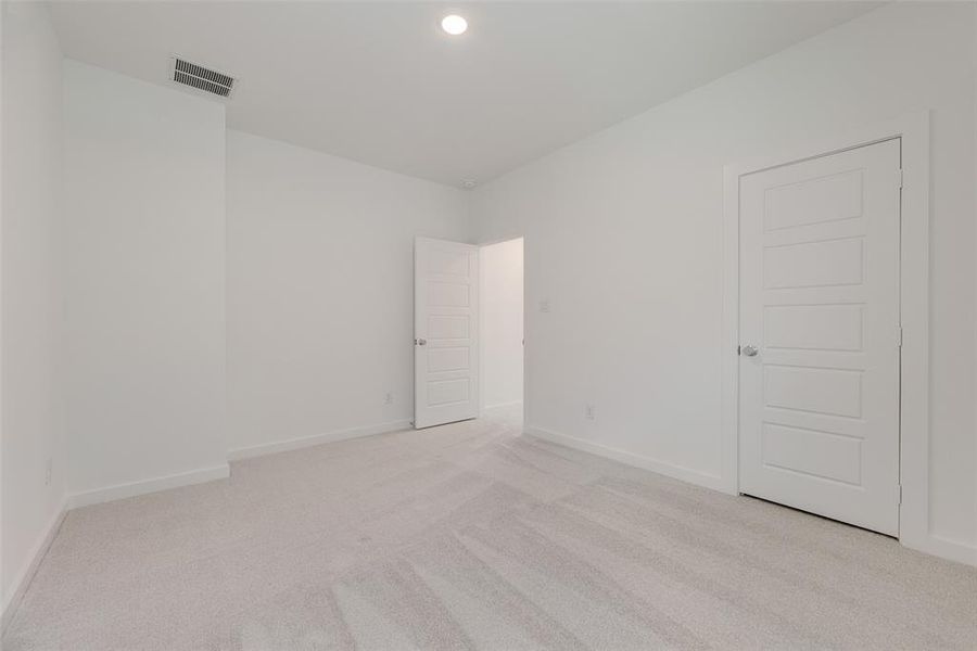 Unfurnished room featuring light carpet and recessed lighting Unfurnished room featuring light carpet and recessed lighting
