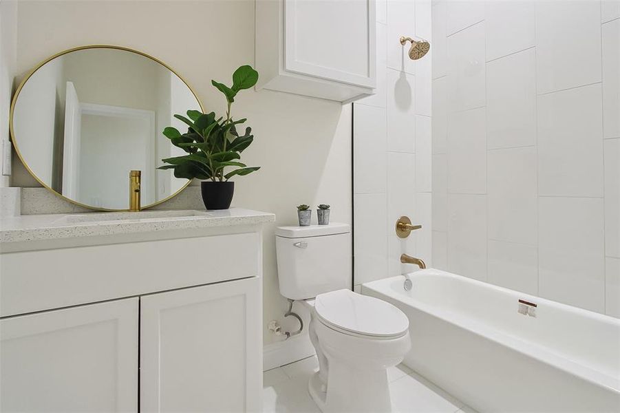 Full bathroom featuring shower / tub combination, vanity, tile patterned flooring, and toilet