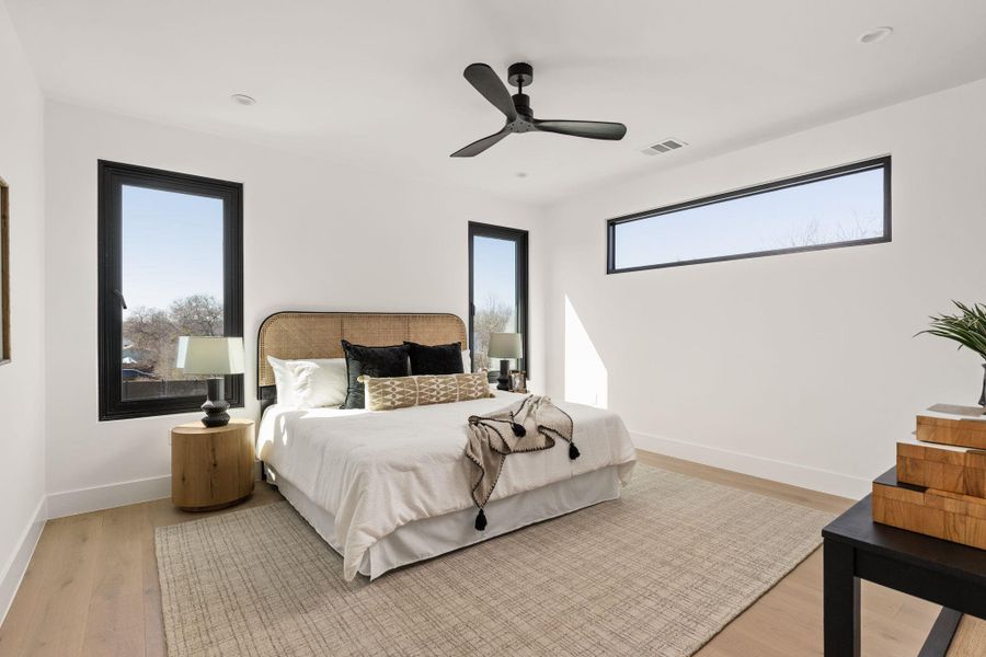 Bedroom with light wood finished floors and ceiling fan