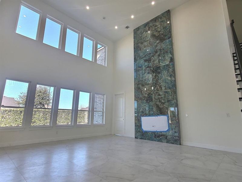 Unfurnished living room featuring a high ceiling tiles Firs place