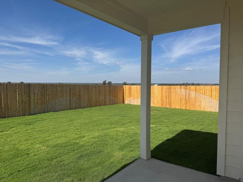 Fenced backyard with a patio area Fenced backyard with a patio area