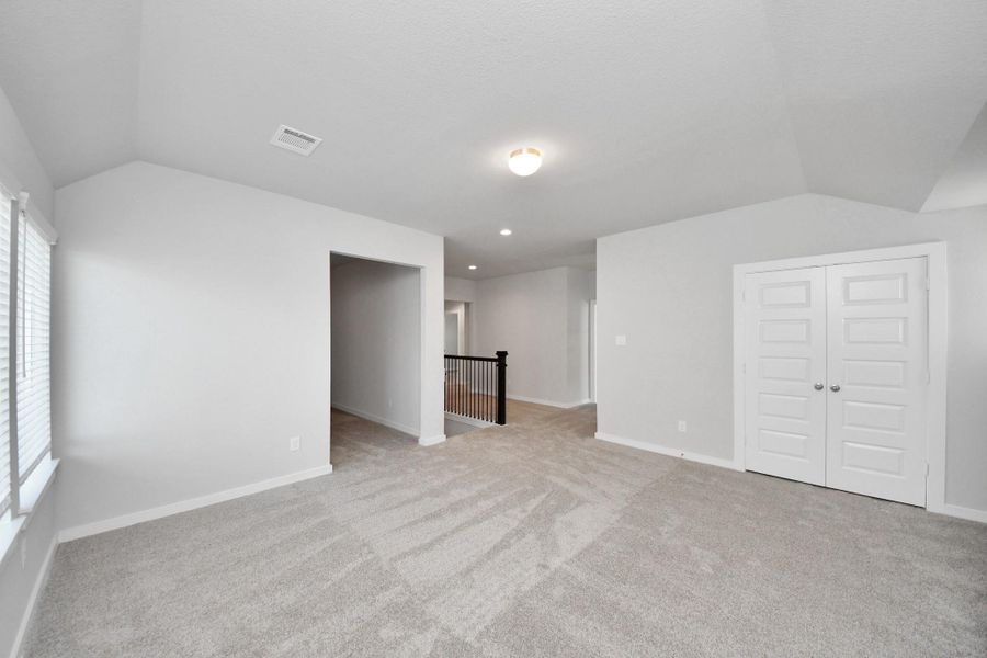 Come upstairs and enjoy a day of leisure in this fabulous game room! This is the perfect hangout spot or adult game room! Features plush carpet, high ceilings, custom paint and windows for plenty of natural light. Sample photo of completed home with similar floor plan. Actual colors and selections may vary. Come upstairs and enjoy a day of leisure in this fabulous game room! This is the perfect hangout spot or adult game room! Features plush carpet, high ceilings, custom paint and windows for plenty of natural light. Sample photo of completed home with similar floor plan. Actual colors and selections may vary.