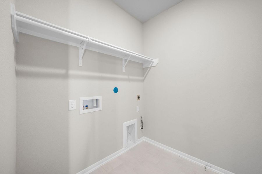 The laundry room layout is carefully planned for optimal workflow with designated areas for washing, drying, and storing.