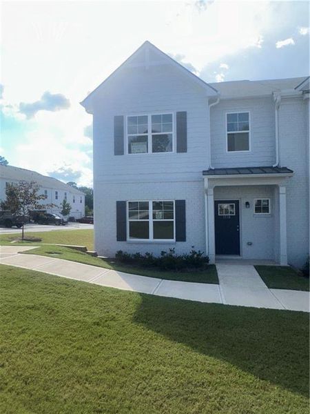 Front exterior of a new home in Shoals Crossing, Conyers, GA, highlighting curb appeal (Image 1). Front exterior of a new home in Shoals Crossing, Conyers, GA, highlighting curb appeal (Image 1).