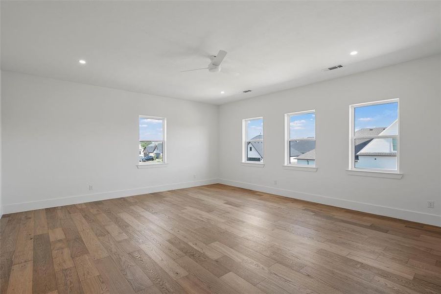 Empty room featuring light wood-style floors, recessed lighting, and ceiling fan Empty room featuring light wood-style floors, recessed lighting, and ceiling fan