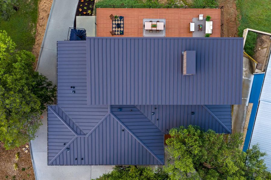 Modern metal roof with multiple gables and a chimney Modern metal roof with multiple gables and a chimney