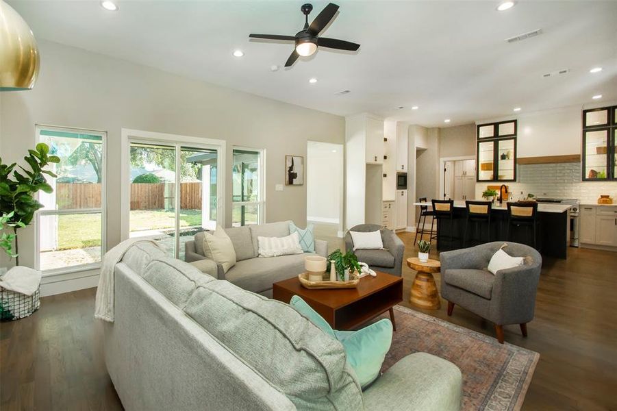 Living room featuring ceiling fan and dark hardwood / wood-style flooring