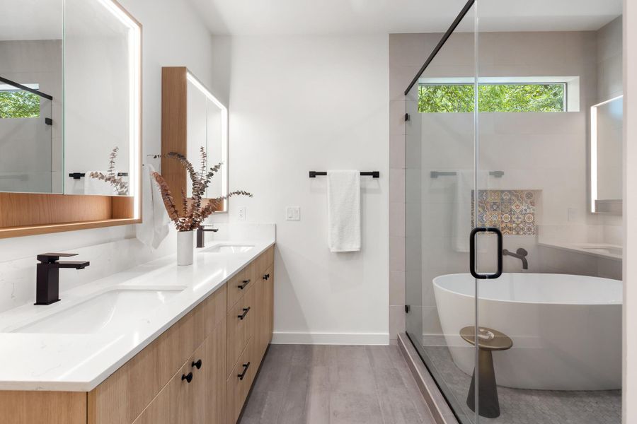 The luxurious primary bathroom creates a relaxing space for beginning and ending the day. The luxurious primary bathroom creates a relaxing space for beginning and ending the day.