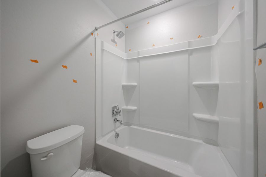 A bathroom with a tub toilet and sink. A bathroom with a tub toilet and sink.