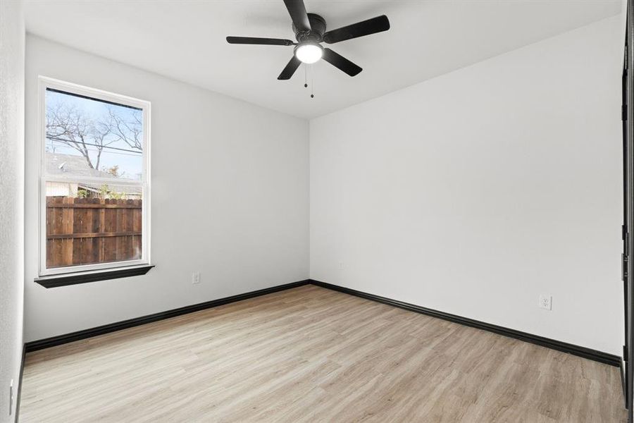 Unfurnished room with light hardwood / wood-style flooring and ceiling fan