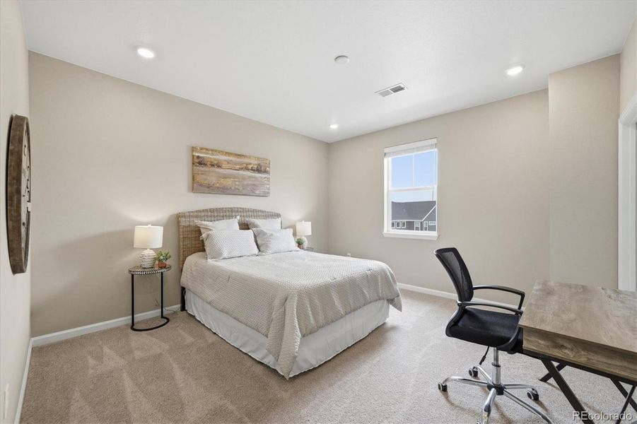 Bedroom #2 with a walk in closet and en suite full bathroom.