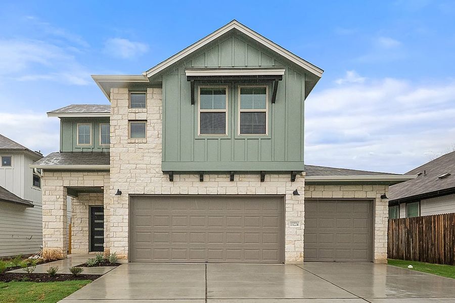 Front exterior of a new home in The Hills of Bear Creek, Manchaca, TX, highlighting curb appeal (Image 25). Front exterior of a new home in The Hills of Bear Creek, Manchaca, TX, highlighting curb appeal (Image 25).